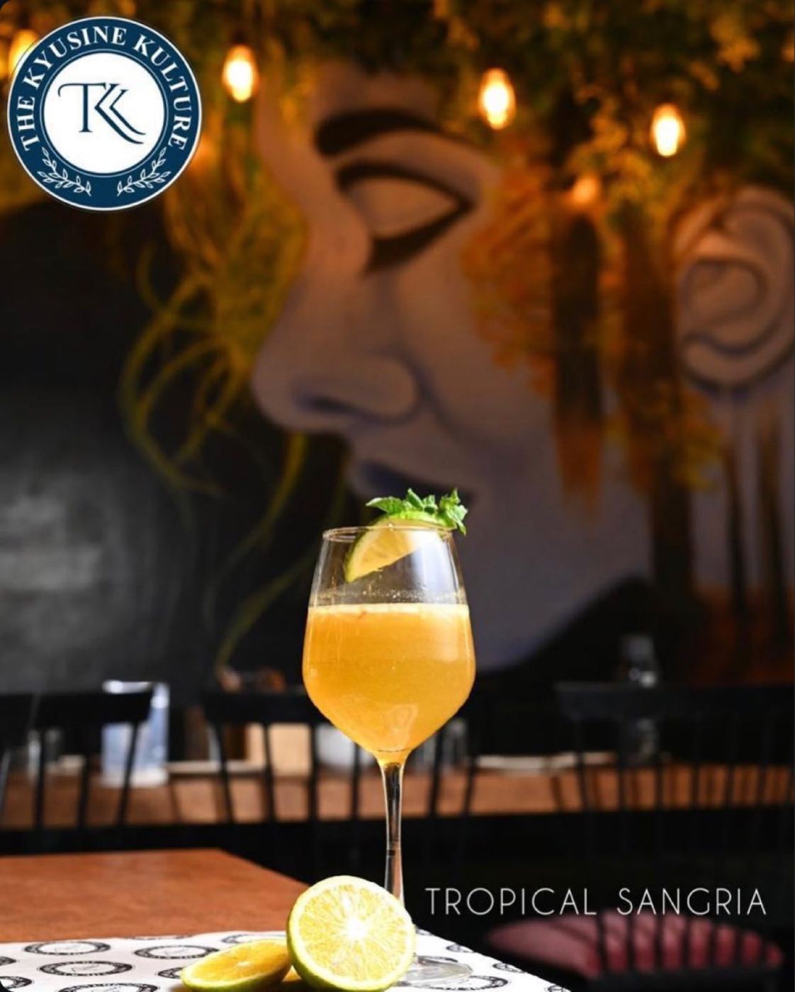 Tropical Sangria mocktail in front of the wall mural